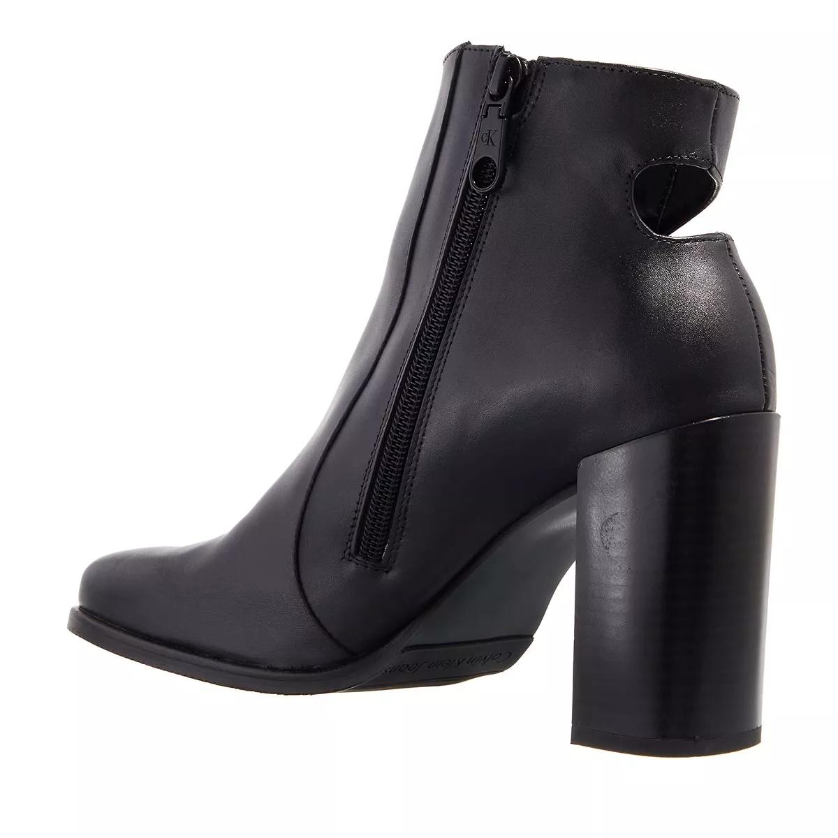 Calvin klein black hot sale boots with gold zipper